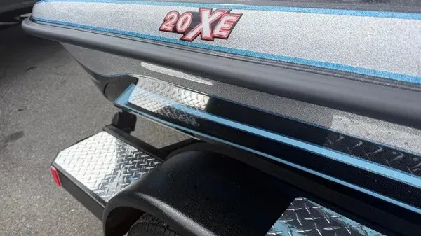 Slide: The Image of Close-up of a Phoenix 20 XE boat's rear with shiny paint and trailer. - 3