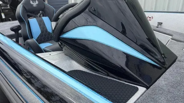 Slide: The Image of The image shows a modern boat with a sleek black and blue design. The seat is cushioned and comfortable. - 4