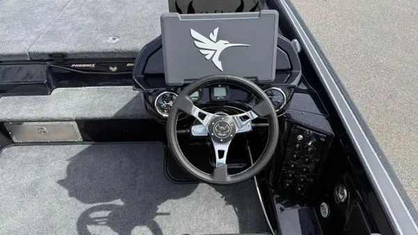 Slide: The Image of The image shows the cockpit of a 2027 Phoenix 921 Elite X boat with a modern helm. - 20