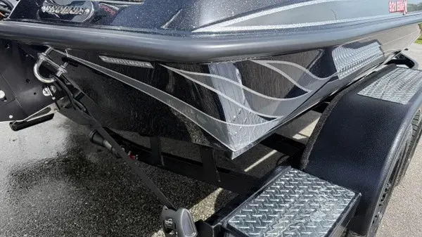 Slide: The Image of The image shows the bow of a 2027 Phoenix 921 Elite X boat on a trailer. - 4