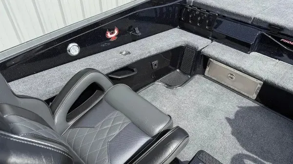 Slide: The Image of Interior of a 2027 Phoenix 921 Elite X with gray carpet and black seating. - 19