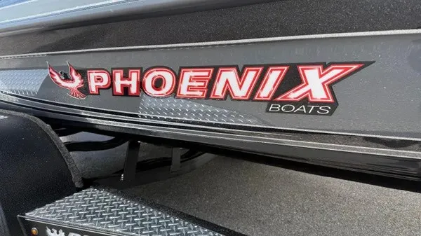 Slide: The Image of Close-up of the Phoenix 921 Elite X with a distinctive logo on the boat's side. - 2