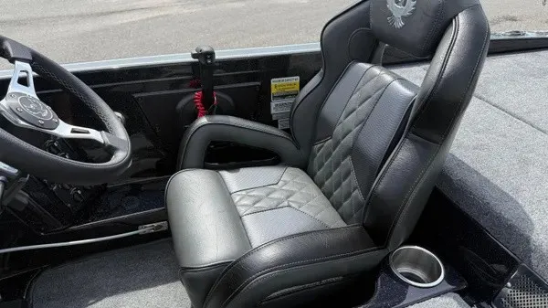Slide: The Image of The 2027 Phoenix 921 Elite X features a luxurious driver's seat with quilted leather and a cup holder. - 16