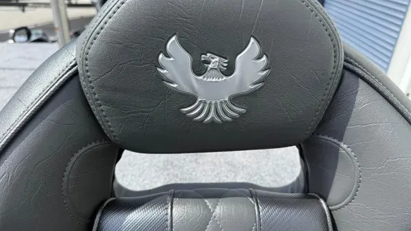 Slide: The Image of Close-up of a gray leather seat with an engraved Phoenix logo. - 15