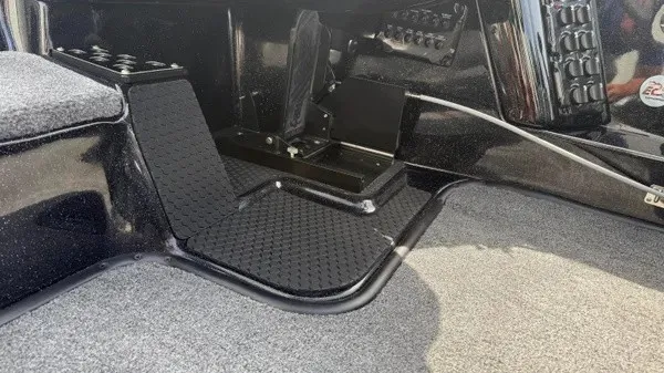 Slide: The Image of Interior view of a 2027 Phoenix 921 Elite X boat with gray carpeting and black details. - 18