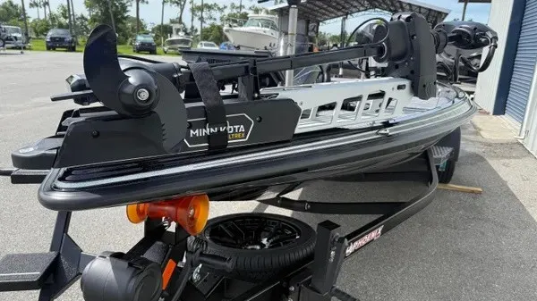 Slide: The Image of A 2027 Phoenix 921 Elite X boat on a trailer, featuring a Minn Kota trolling motor. - 10