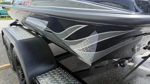 Slide: The Image of The image shows a 2027 Phoenix 921 Elite X boat with stylish gray flame accents. - 7