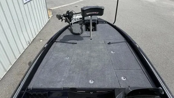 Slide: The Image of The image shows the deck of a 2027 Phoenix 921 Elite X boat with gray carpeting. - 12