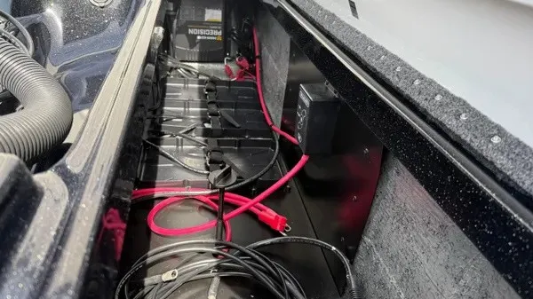 Slide: The Image of A view inside the battery compartment of a 2027 Phoenix 921 Elite X boat with red cables. - 21