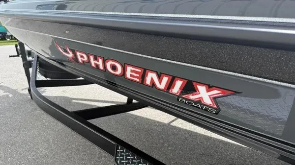 Slide: The Image of Close-up of the Phoenix 921 Elite X boat hull with prominent logo. - 8