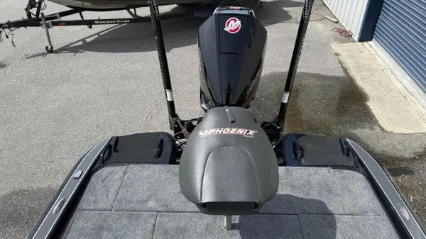 Slide: The Image of The image shows the rear of a 2027 Phoenix 921 Elite X boat with an engine. - 11