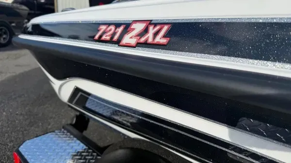 Slide: The Image of Close-up of the Phoenix 721 ZXL boat with a sleek black and white design. - 3