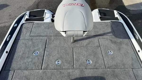 Slide: The Image of The image shows the deck of a Phoenix 721 ZXL boat with gray carpeting and a seat. - 19