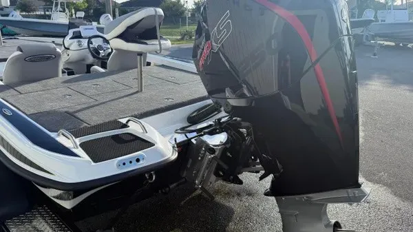 Slide: The Image of A Phoenix 721 ZXL boat with a powerful outboard motor, parked on a trailer. - 6