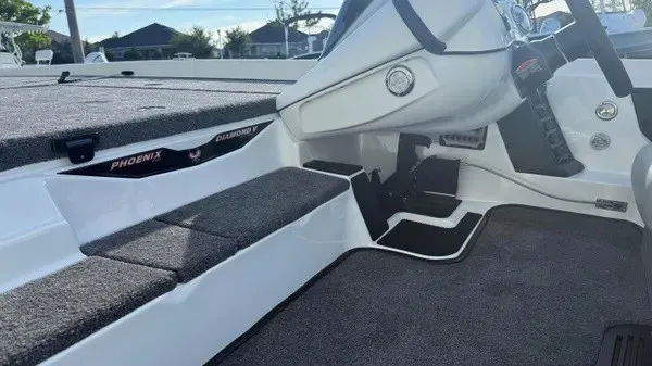 Slide: The Image of Interior view of a Phoenix 721 ZXL boat with gray carpeting and white accents. - 23