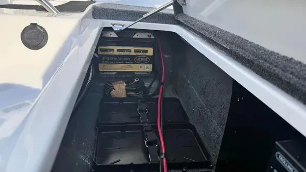 Slide: The Image of A battery compartment in a boat with multiple batteries and cables. - 24