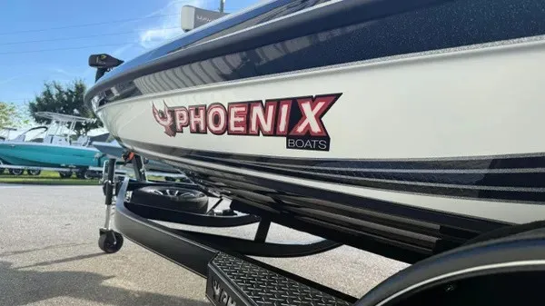 Slide: The Image of A Phoenix 721 ZXL boat on a trailer, with a clear sky in the background. - 8