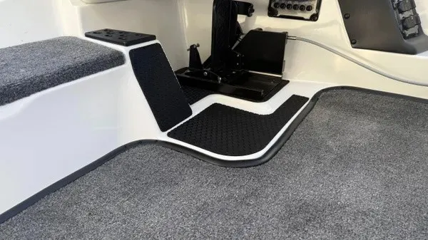 Slide: The Image of The image shows the interior of a Phoenix 721 ZXL boat with gray carpeting. - 18