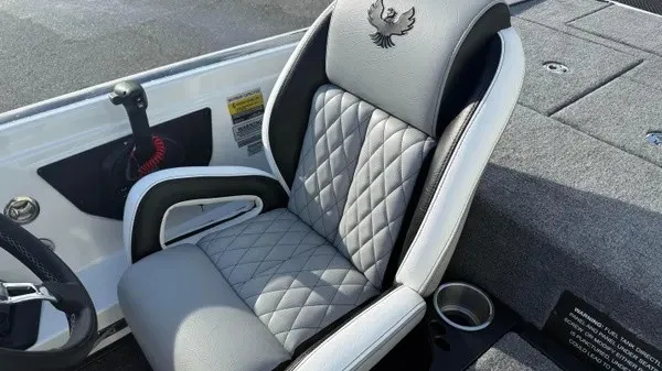 Slide: The Image of A luxurious gray seat with quilted pattern and a phoenix logo on a boat. - 16
