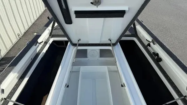 Slide: The Image of The image shows the open storage compartment of a 2027 Phoenix 721 ZXL boat. - 12