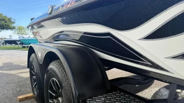 Slide: The Image of Side view of a 2027 Phoenix 721 ZXL boat with sleek design and dual axles. - 7