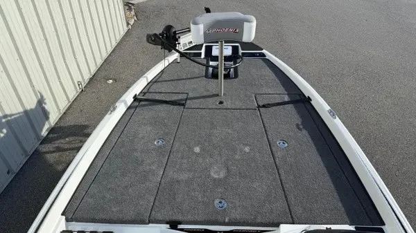 Slide: The Image of The image shows the deck of a 2027 Phoenix 721 ZXL boat with gray carpeting. - 11