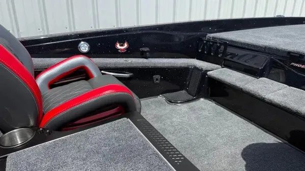 Slide: The Image of The image shows the cockpit of a Phoenix 919 ZXL boat with gray and red seating. - 27