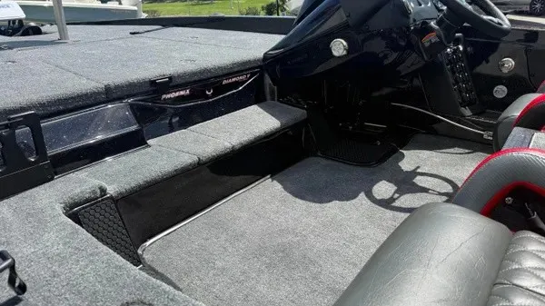 Slide: The Image of The image shows the cockpit of a 2027 Phoenix 919 ZXL boat with gray upholstery and a black helm. - 26