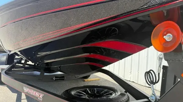 Slide: The Image of Close-up of a Phoenix 919 ZXL boat hull with red stripe pattern. - 13