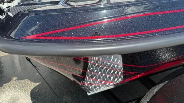 Slide: The Image of Close-up of a shiny Phoenix 919 ZXL hull with red stripes. - 4