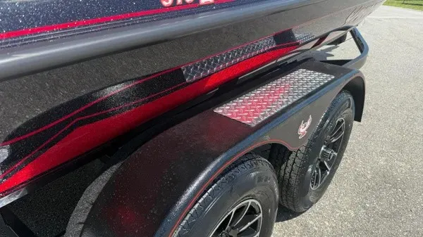 Slide: The Image of Close-up of a boat trailer with red and black accents and diamond-patterned step plates. - 3