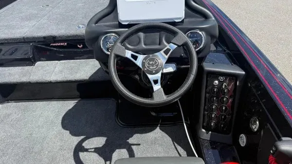 Slide: The Image of The image shows the cockpit of a Phoenix 919 ZXL boat with a modern steering wheel and instruments. - 22