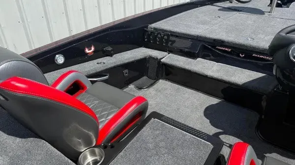 Slide: The Image of The image shows the cockpit of a Phoenix 919 ZXL boat with red and gray seats. - 24