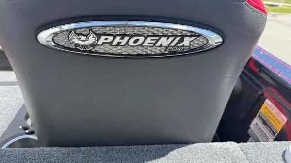 Slide: The Image of Back of a boat seat with Phoenix logo, surrounded by gray upholstery. - 23