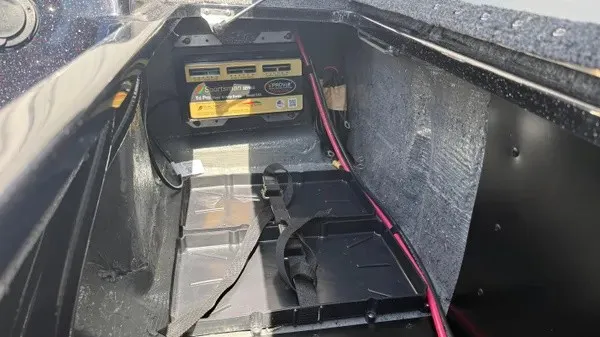 Slide: The Image of Interior view of a boat storage compartment with batteries and wiring. - 28