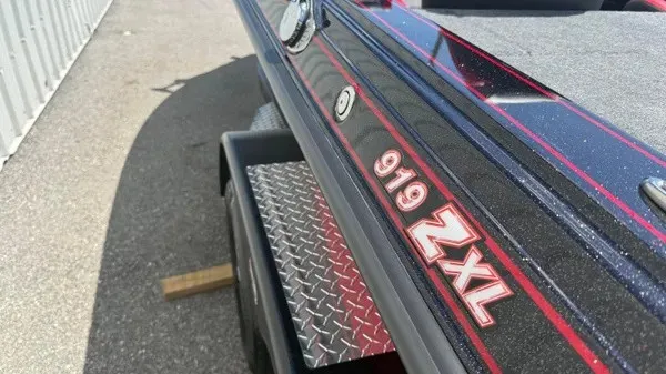 Slide: The Image of Close-up of the Phoenix 919 ZXL boat with a glossy black hull and red accents. - 10