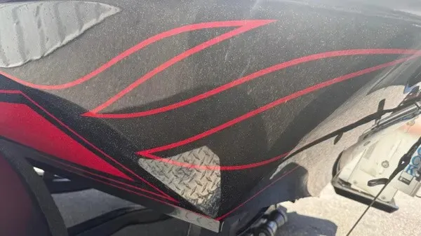 Slide: The Image of Close-up of a Phoenix 919 ZXL boat hull with red stripes. - 9