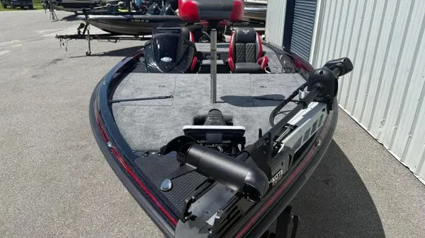 Slide: The Image of The image shows a 2027 Phoenix 919 ZXL boat with a gray deck and red seats. - 12