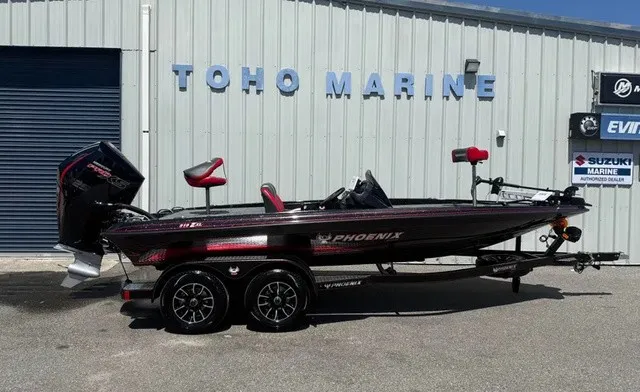 The Image of A 2027 Phoenix 919 ZXL boat on a trailer in front of a building labeled "TOHO MARINE." - 1