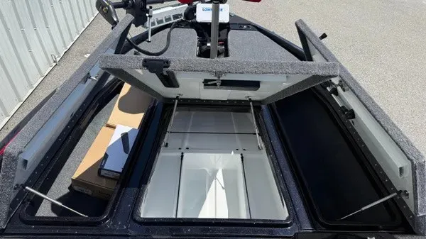 Slide: The Image of The image shows the storage area of a 2027 Phoenix 919 ZXL boat with open hatches. - 15