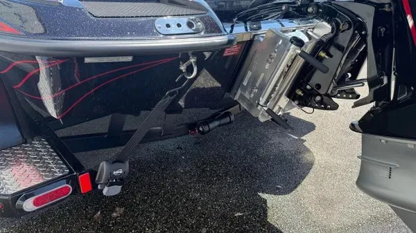 Slide: The Image of The image shows the rear of a Phoenix 919 ZXL boat with motor and trailer hitch. - 8