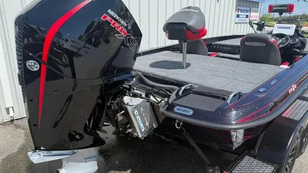 Slide: The Image of A Phoenix 919 ZXL boat with a powerful outboard motor, gray deck, and red accents. - 5