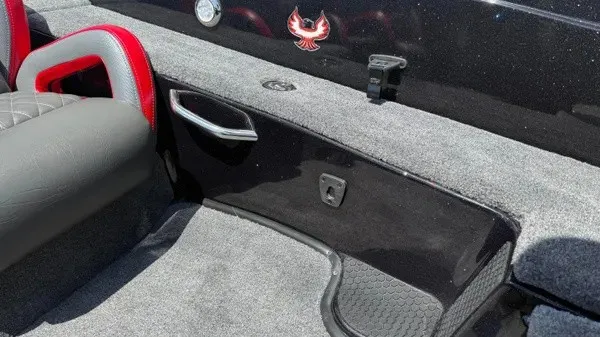 Slide: The Image of The image shows the interior of a Phoenix 919 ZXL boat with gray carpet and red accents. - 18