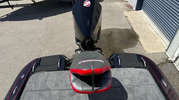 Slide: The Image of The image shows the rear of a Phoenix 919 ZXL boat with an engine and a seat. - 25
