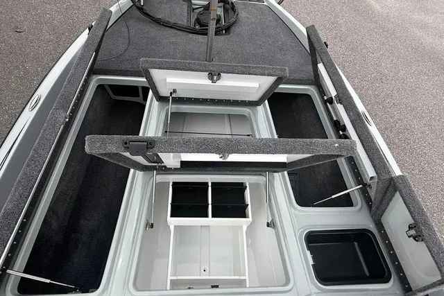 Slide: The Image of The image shows the deck of a Phoenix 921 Elite X II boat with multiple open storage compartments. - 19