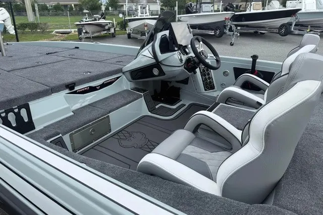 Slide: The Image of The image shows the cockpit of a 2027 Phoenix 921 Elite X II boat with gray seats and modern controls. - 21