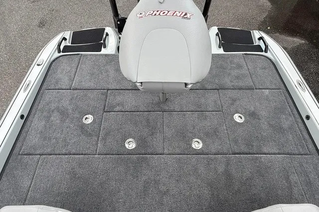Slide: The Image of The image shows the gray padded deck of a Phoenix 921 Elite X II boat. - 12