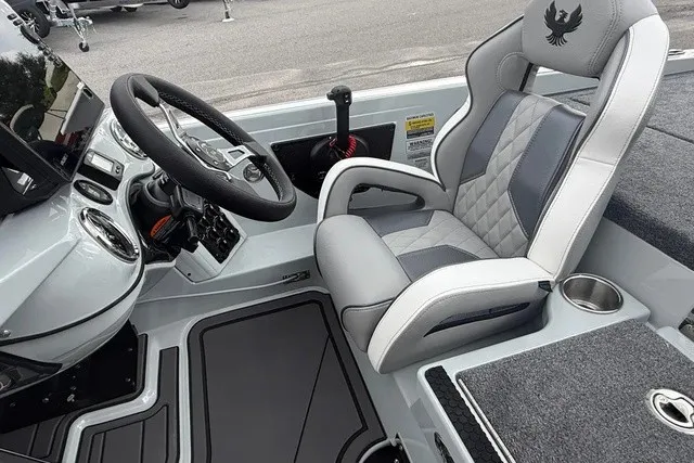Slide: The Image of The image shows the helm of a 2027 Phoenix 921 Elite X II boat with a luxurious seat. - 13