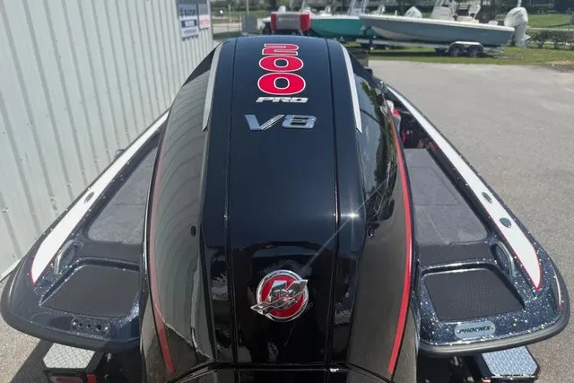 Slide: The Image of A Phoenix 819 ZXL boat with a powerful 200 Pro V8 engine, parked in a yard. - 5