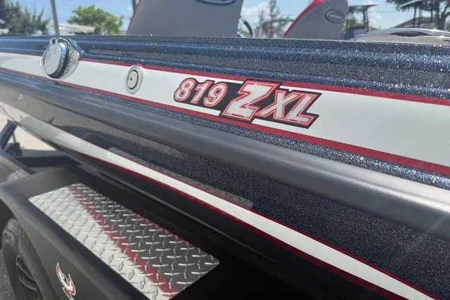 Slide: The Image of Close-up of the Phoenix 819 ZXL boat with a shiny hull and distinctive logo. - 8